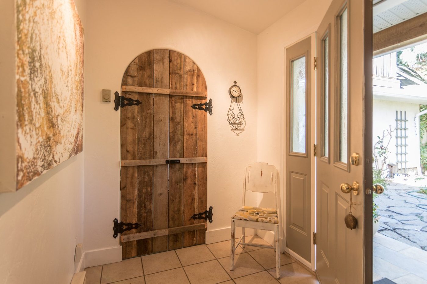 A rustic arched timber door in the hallway